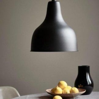 Czarna lampa wisząca do kuchni i jadalni w kształcie dzwonu nad stołem z owocami. Metalowa lampa sufitowa w matowym wykończeniu idealna nad stół jadalny. Minimalistyczne oświetlenie w nowoczesnym stylu.