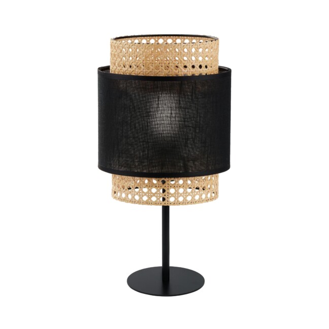 Stylowa lampa stołowa Boho Nature z plecionym, rattanowym kloszem w naturalnym kolorze, uzupełnionym czarnym, tekstylnym pasem pośrodku. Osadzona na smukłej, metalowej nóżce z okrągłą podstawą. Ażurowa konstrukcja klosza tworzy ciekawy wzór światła i cienia. Idealna do wnętrz w stylu boho jako nastrojowe oświetlenie szafki nocnej lub komody.