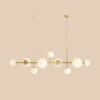 Stylowa lampa wisząca Dione 9 w odcieniu mosiądzu, idealna do salonu